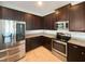 Modern kitchen with stainless steel appliances and dark brown cabinets at 7574 Marker Ave, Kissimmee, FL 34747