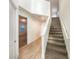 Modern staircase with carpeted steps and tile flooring on the landing at 7574 Marker Ave, Kissimmee, FL 34747