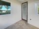 Small balcony with a door and window overlooking trees and homes at 7574 Marker Ave, Kissimmee, FL 34747