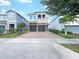Two-story house with a two-car garage and well-manicured lawn at 7574 Marker Ave, Kissimmee, FL 34747