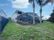 Private backyard oasis with a screened pool and lush landscaping at 7574 Marker Ave, Kissimmee, FL 34747