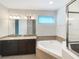 Bathroom with granite vanity, soaking tub, and shower at 7574 Marker Ave, Kissimmee, FL 34747