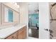 Bathroom with a vanity, mirror, and view into bedroom at 2490 Zuni Rd, St Cloud, FL 34771
