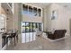 Spacious living room with high ceilings, large windows, and a view of the backyard at 2490 Zuni Rd, St Cloud, FL 34771
