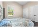 Bedroom with a gray upholstered headboard and double doors to closet at 2490 Zuni Rd, St Cloud, FL 34771
