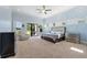 Spacious Primary bedroom with a king-size bed and access to a patio at 2490 Zuni Rd, St Cloud, FL 34771