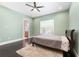 Cozy bedroom with a large window and dark hardwood floors at 2490 Zuni Rd, St Cloud, FL 34771
