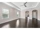 Spacious main bedroom with dark hardwood floors, high ceilings and an arched doorway at 2490 Zuni Rd, St Cloud, FL 34771