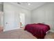 Bedroom with a red comforter and en-suite bathroom access at 2490 Zuni Rd, St Cloud, FL 34771
