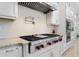 Gourmet kitchen showcasing a Wolf range, custom cabinetry, and granite countertops at 2490 Zuni Rd, St Cloud, FL 34771