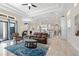 Open living room showcasing a spacious layout, leather seating, and large windows at 2490 Zuni Rd, St Cloud, FL 34771