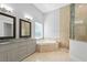 Elegant bathroom with a soaking tub, double vanity, and shower at 2490 Zuni Rd, St Cloud, FL 34771