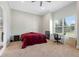 Spacious bedroom with a large window, work area and carpet flooring at 2490 Zuni Rd, St Cloud, FL 34771