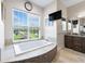 Relaxing bathroom with a free-standing bathtub and large window at 2490 Zuni Rd, St Cloud, FL 34771