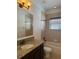 Bathroom with tub, granite vanity and window at 2211 Rickover Pl, Winter Garden, FL 34787
