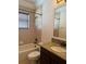 Bathroom with tub, granite vanity and window at 2211 Rickover Pl, Winter Garden, FL 34787