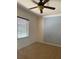 Well-lit bedroom with ceiling fan and accent wall at 2211 Rickover Pl, Winter Garden, FL 34787