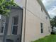 Tan stucco exterior with windows and landscaping at 2211 Rickover Pl, Winter Garden, FL 34787
