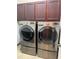 Bright laundry room, features washer, dryer, cabinets, and utility sink at 2211 Rickover Pl, Winter Garden, FL 34787