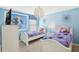 Charming bedroom with two twin beds, Frozen-themed wall art, and a unique chandelier at 1431 Wexford Way, Davenport, FL 33896
