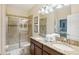 Double vanity bathroom with granite countertops and a large walk-in shower at 1431 Wexford Way, Davenport, FL 33896