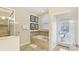 Spa-like bathroom with soaking tub, walk-in shower, and private backyard access at 1431 Wexford Way, Davenport, FL 33896