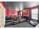 Home theater with brown recliner seating and red walls at 1431 Wexford Way, Davenport, FL 33896