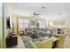 Spacious living room featuring a large sectional sofa and a flat-screen TV at 1431 Wexford Way, Davenport, FL 33896