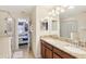 Double vanity with granite countertops and a walk-in shower at 1431 Wexford Way, Davenport, FL 33896