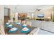 Open concept dining room with a large table and chairs, adjacent to the kitchen and living room at 1431 Wexford Way, Davenport, FL 33896