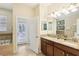 Bathroom with double vanity, large soaking tub, and private access to backyard at 1431 Wexford Way, Davenport, FL 33896