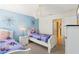 Welcoming bedroom with two twin beds, Frozen-themed decor, and access to a bathroom at 1431 Wexford Way, Davenport, FL 33896