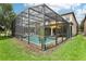 Screened pool and spa area with lush landscaping at 1431 Wexford Way, Davenport, FL 33896