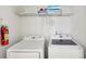 Laundry room with washer, dryer, and shelving for linens at 1431 Wexford Way, Davenport, FL 33896