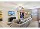 Relaxing living room with sectional sofa and large TV for entertainment at 1431 Wexford Way, Davenport, FL 33896