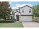 Two story house with stone accents and landscaping at 1431 Wexford Way, Davenport, FL 33896