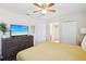 Comfortable bedroom with a large bed, dresser, and en-suite bathroom at 1431 Wexford Way, Davenport, FL 33896