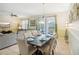 Bright dining area with a glass-top table and seating for eight, overlooking the pool at 1431 Wexford Way, Davenport, FL 33896