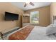 Bright bedroom featuring a full-size bed and a large window at 8101 Coconut Palm Way # 203, Kissimmee, FL 34747