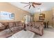 Living room with brown couches and view of dining area at 8101 Coconut Palm Way # 203, Kissimmee, FL 34747