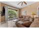 Living room with brown couches and balcony view at 8101 Coconut Palm Way # 203, Kissimmee, FL 34747