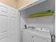 Laundry closet with washer, dryer, and shelving at 8101 Coconut Palm Way # 203, Kissimmee, FL 34747