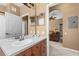 Bathroom with double vanity, view into living room at 8101 Coconut Palm Way # 203, Kissimmee, FL 34747