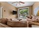 Living room with brown couch and access to balcony at 8101 Coconut Palm Way # 203, Kissimmee, FL 34747