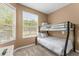 Bedroom with a full-over-full bunk bed and large window at 8101 Coconut Palm Way # 203, Kissimmee, FL 34747