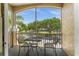 Screened balcony with small table and chairs, overlooking community at 8101 Coconut Palm Way # 203, Kissimmee, FL 34747
