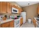 Well-equipped kitchen with wood cabinets and appliances at 8101 Coconut Palm Way # 203, Kissimmee, FL 34747