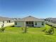 House in a large backyard with grassy lawn at 17926 Hither Hills Cir, Winter Garden, FL 34787