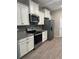 Modern kitchen with white cabinets, granite countertops, and stainless steel appliances at 17926 Hither Hills Cir, Winter Garden, FL 34787