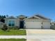 Two-story house with a three-car garage and landscaped lawn at 17926 Hither Hills Cir, Winter Garden, FL 34787